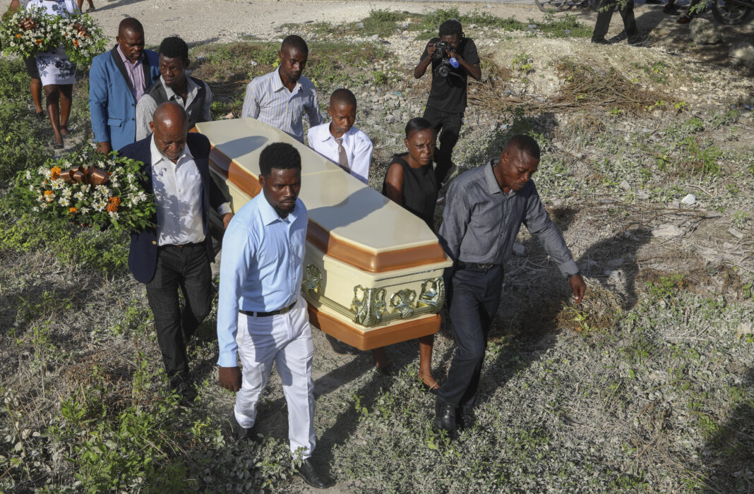 A Haiti gang attack on the reopening of a main hospital kills 2 reporters and a police officer